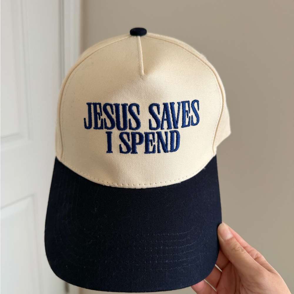 SOLD Jesus Saves I Spend Cream and Navy Cap with Embroidered Text